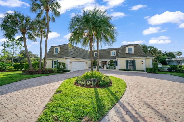 view of front of home featuring a garage and a front lawn