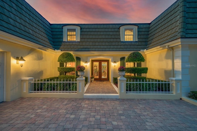 exterior entry at dusk with french doors