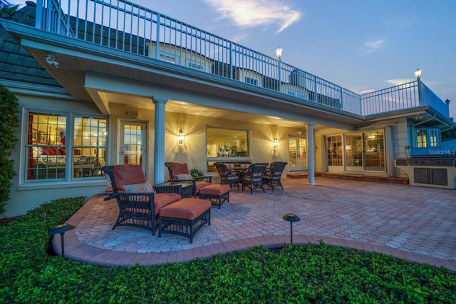 patio terrace at dusk with a balcony