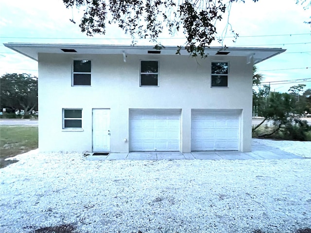 back of property featuring a garage