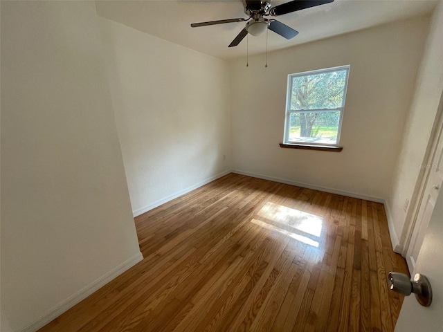 spare room featuring ceiling fan and dark wood-type flooring