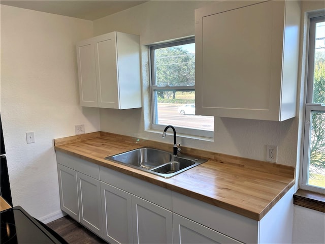 kitchen with white cabinets and a healthy amount of sunlight