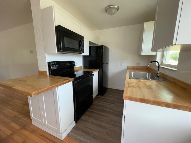 kitchen featuring wood counters, white cabinets, and black appliances