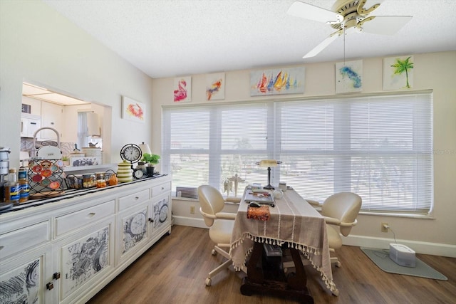 dining area featuring ceiling fan, a textured ceiling, baseboards, and wood finished floors