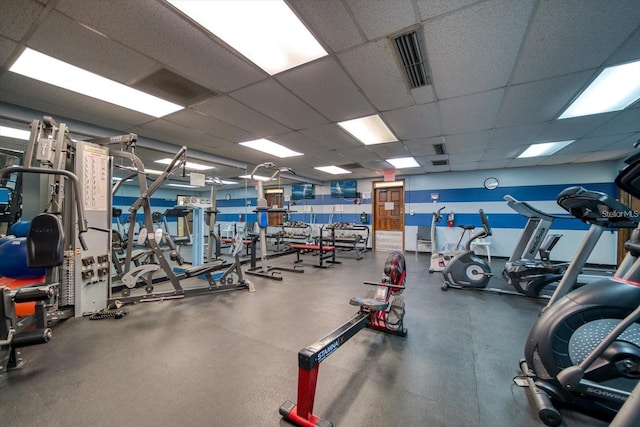 workout area featuring a paneled ceiling