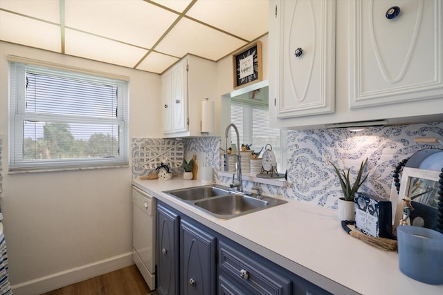 kitchen featuring a sink, white cabinets, light countertops, blue cabinetry, and dishwasher