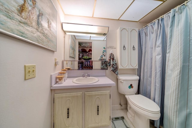 bathroom with vanity, toilet, and tile patterned floors