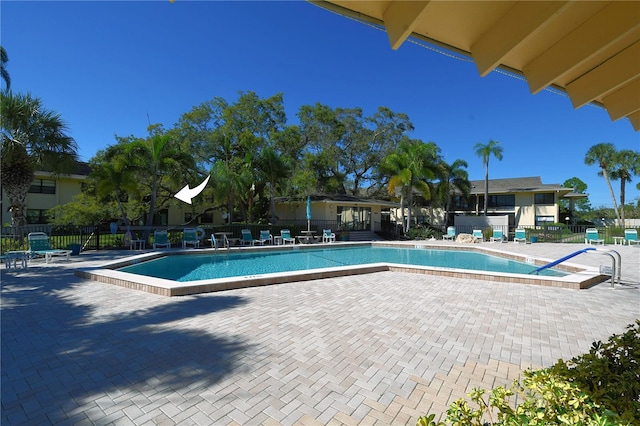 community pool featuring a patio area and fence