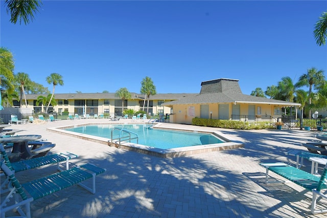 pool featuring fence and a patio