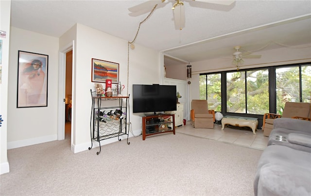 living room with a ceiling fan, light colored carpet, and baseboards