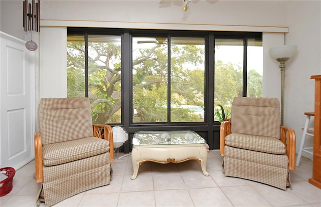 living area with light tile patterned flooring, ceiling fan, and plenty of natural light