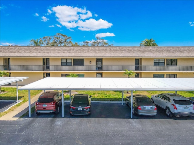 view of building exterior with covered parking