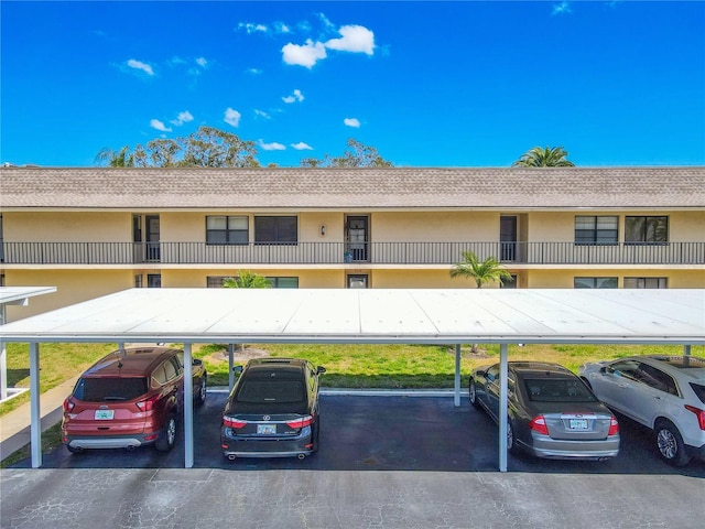 view of building exterior featuring covered parking