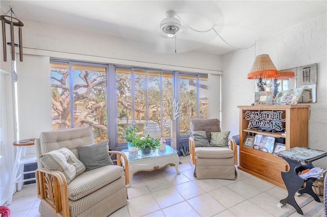 living area with tile patterned floors and ceiling fan