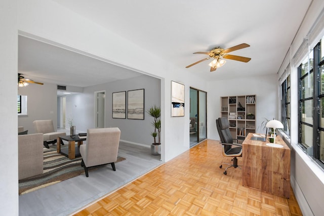 office featuring ceiling fan, plenty of natural light, and light parquet floors