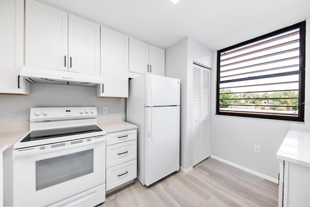 kitchen featuring white appliances, light hardwood / wood-style floors, and white cabinets