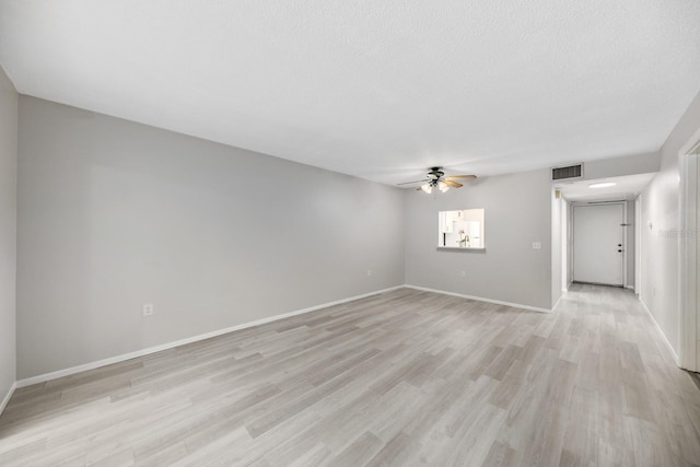 unfurnished room featuring a textured ceiling, ceiling fan, and light wood-type flooring