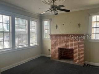 unfurnished living room featuring crown molding, a fireplace, and ceiling fan