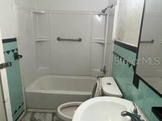 bathroom featuring shower / bath combination, tile flooring, and toilet