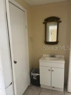 bathroom featuring tile floors and oversized vanity