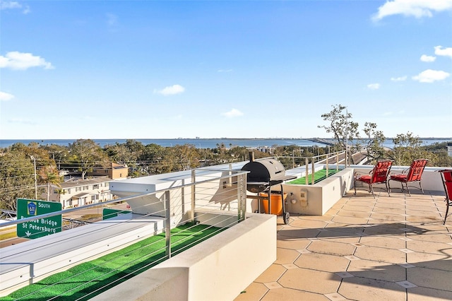 view of patio / terrace featuring a water view and grilling area