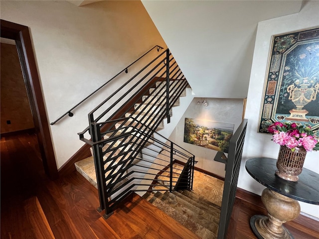 stairs featuring hardwood / wood-style floors