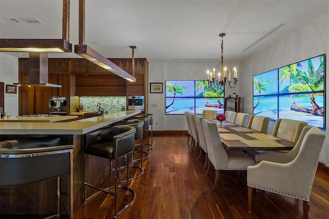 dining room with dark wood-type flooring and a chandelier