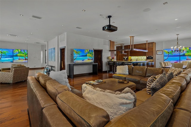 living room with an inviting chandelier and dark hardwood / wood-style flooring