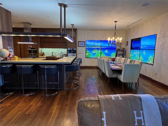 dining room with dark hardwood / wood-style floors and a chandelier