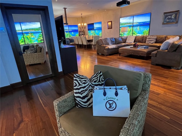 living room with dark hardwood / wood-style flooring and a notable chandelier