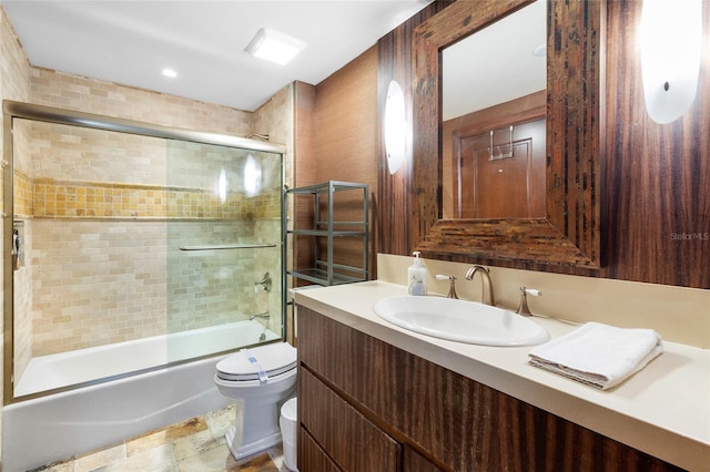 full bathroom with vanity, enclosed tub / shower combo, and toilet