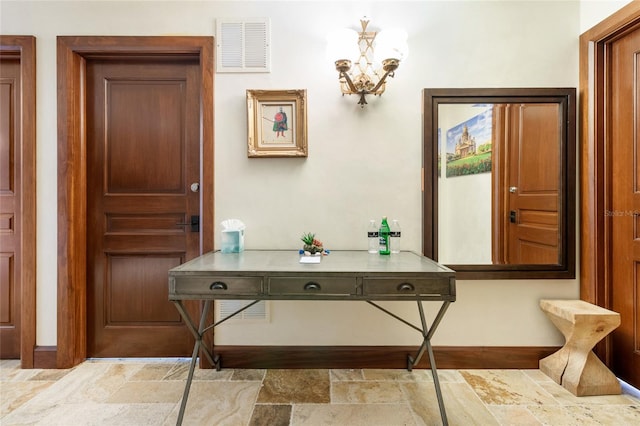 entryway with an inviting chandelier