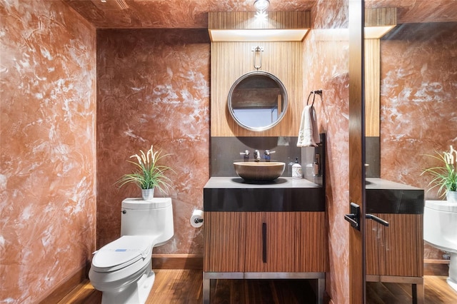 bathroom with vanity, hardwood / wood-style floors, backsplash, and toilet