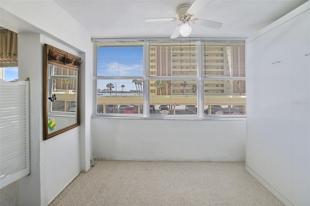 carpeted empty room with ceiling fan