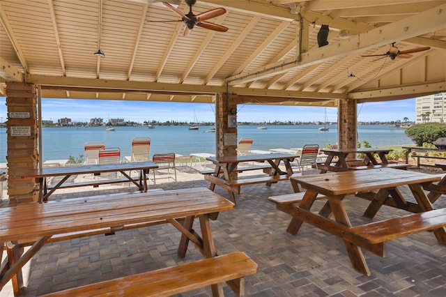 view of terrace featuring a water view and ceiling fan