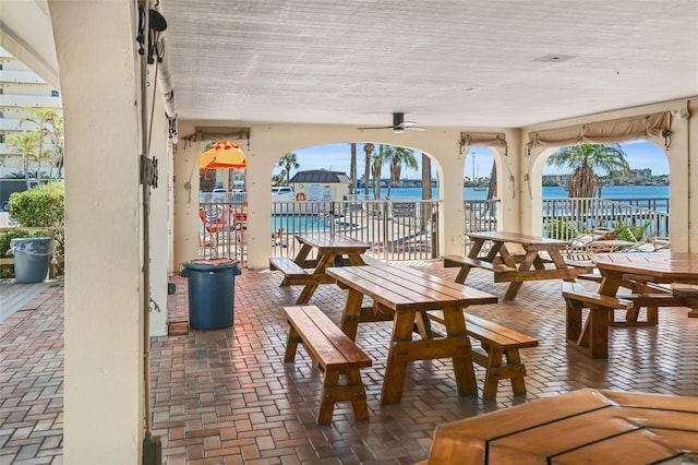 interior space featuring ceiling fan and a water view