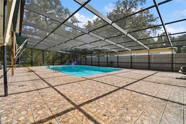 view of swimming pool featuring a patio and a lanai