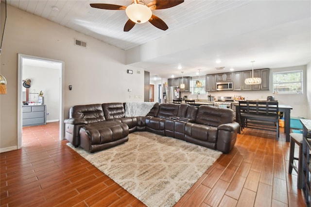 living room with hardwood / wood-style floors and ceiling fan