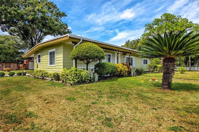 view of property exterior with a lawn