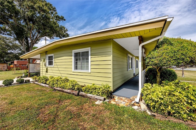 view of side of home with a lawn