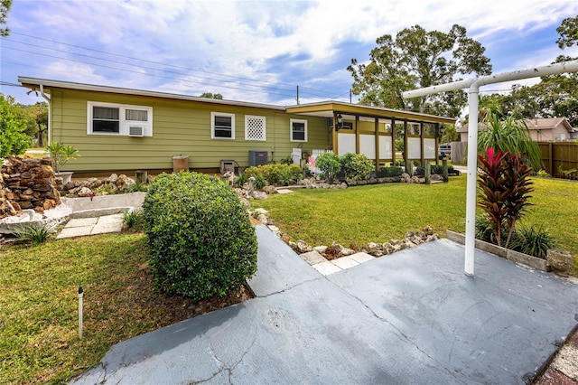 rear view of property featuring a yard