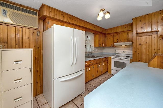 kitchen featuring light tile floors, white appliances, sink, and a wall unit AC