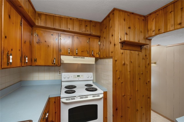 kitchen featuring backsplash, a textured ceiling, and white electric stove