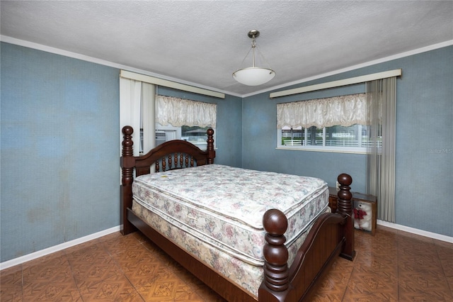 bedroom with dark parquet flooring, ornamental molding, and a textured ceiling