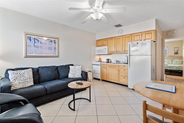 living room featuring light tile flooring and ceiling fan