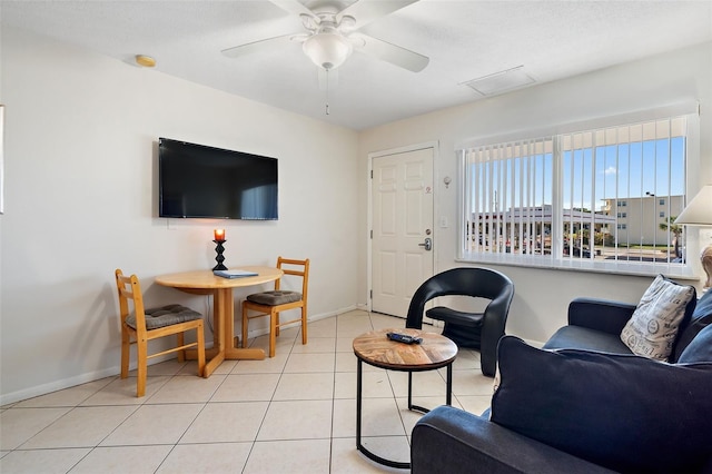 living room featuring light tile floors and ceiling fan