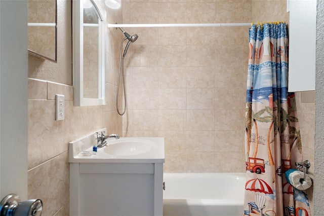 bathroom featuring tile walls, shower / tub combo with curtain, and vanity