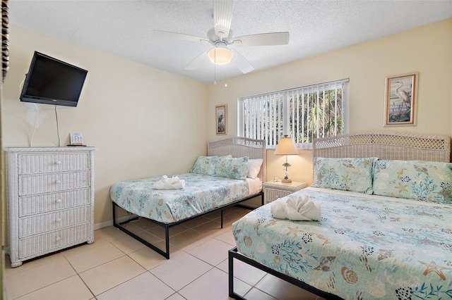 tiled bedroom featuring a textured ceiling and ceiling fan