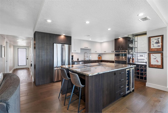 1848 Shore Dr S Unit 501, South Pasadena, FL 33707 - kitchen featuring a sink, stainless steel appliances, wine cooler, visible vents, and baseboards