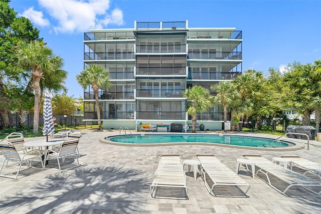 view of swimming pool with a patio